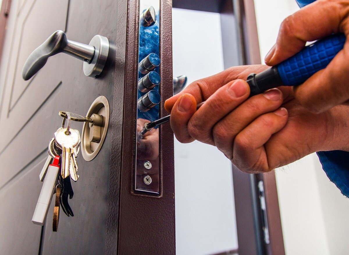 A locksmith repairing a door