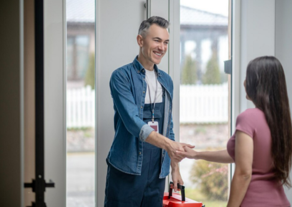 A satisfied girl shaking hands to the locksmith