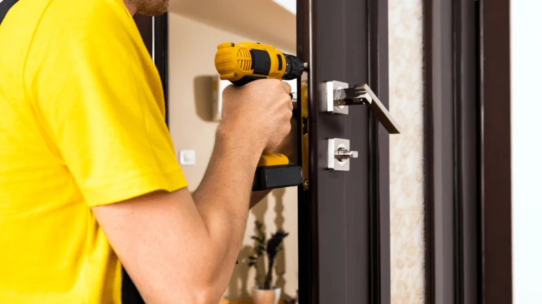 A professional locksmith fixing the doorknob