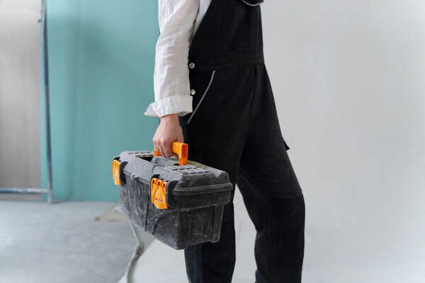 An emergency locksmith carrying tools
