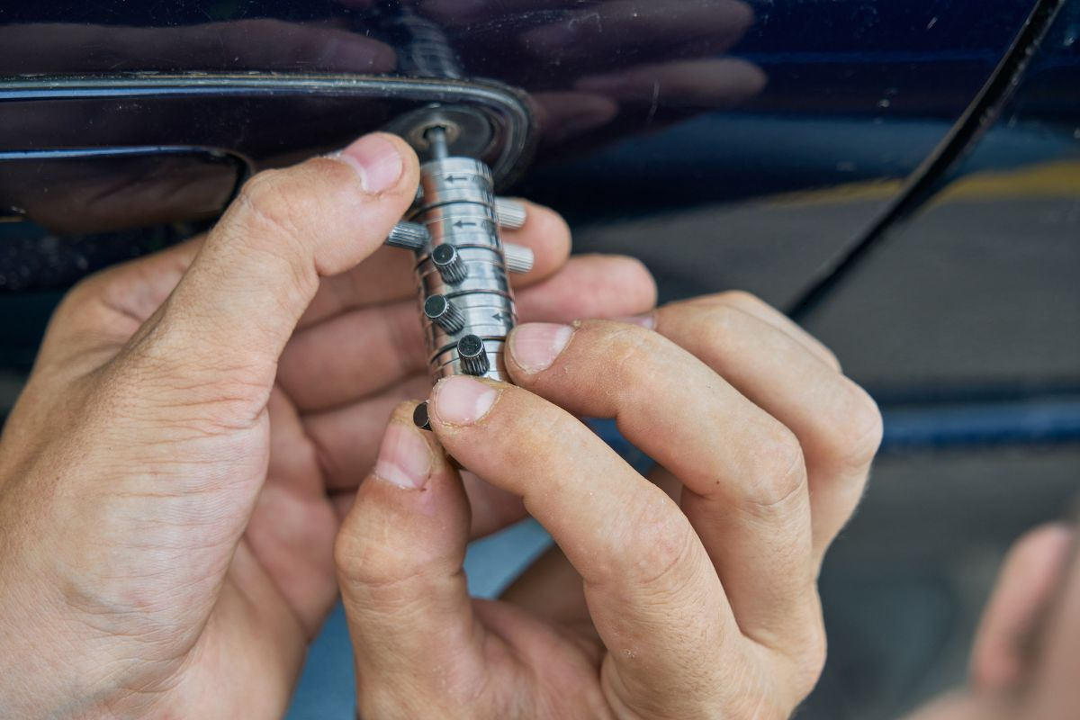 Car locksmith unlocking a car.