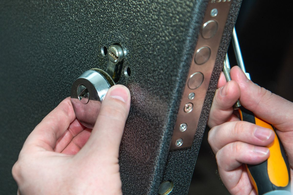 Commercial locksmith repairing a door lock.