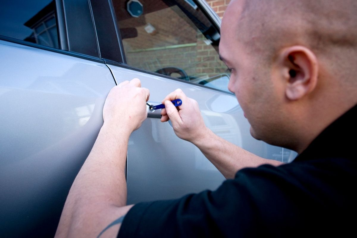 Expert car locksmith unlocking vehicle door quickly