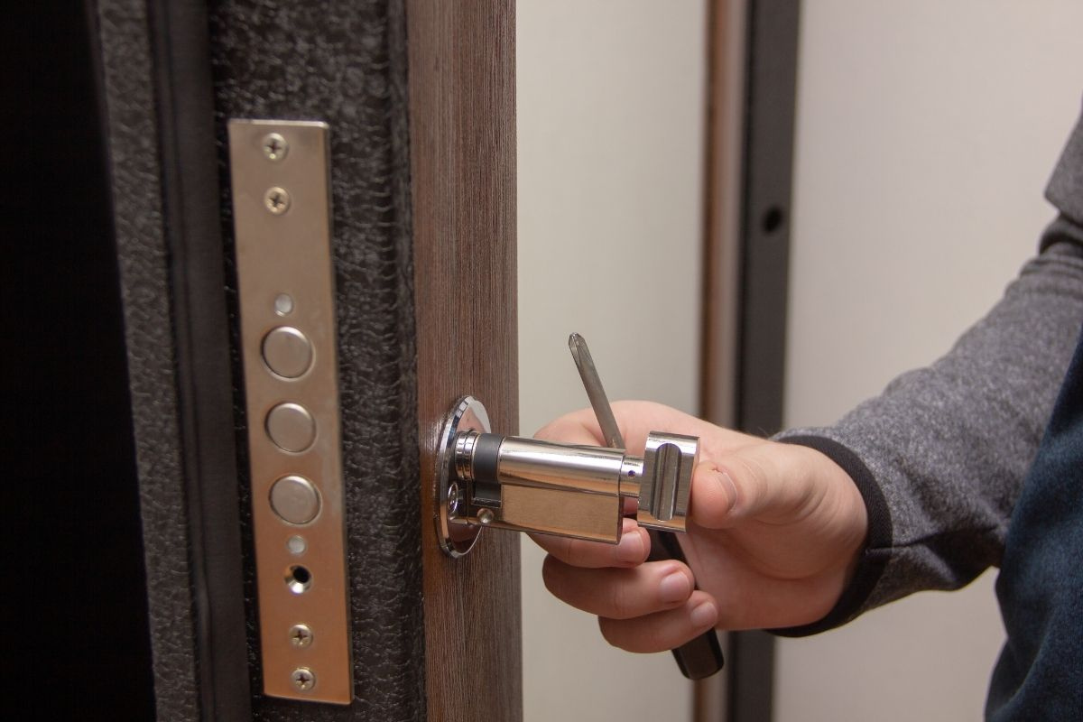 Residential locksmith inspecting front door lock