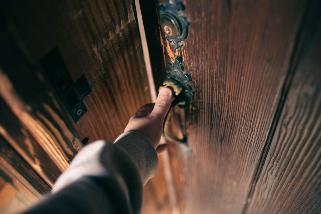 Close-up on a man holding a jammed door handle