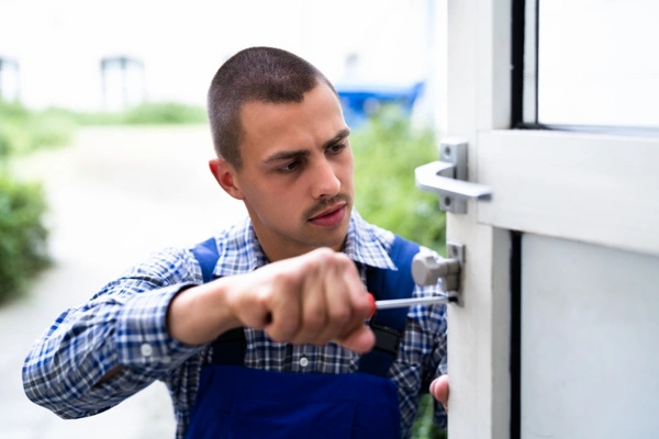 Professional commercial locksmith repairing and installing door locks.