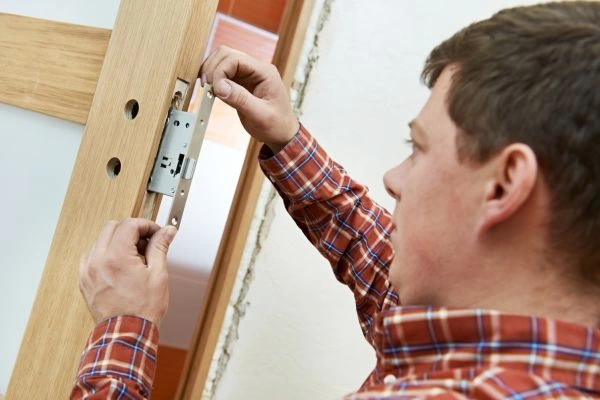 Locksmith upgrading residential door lock
