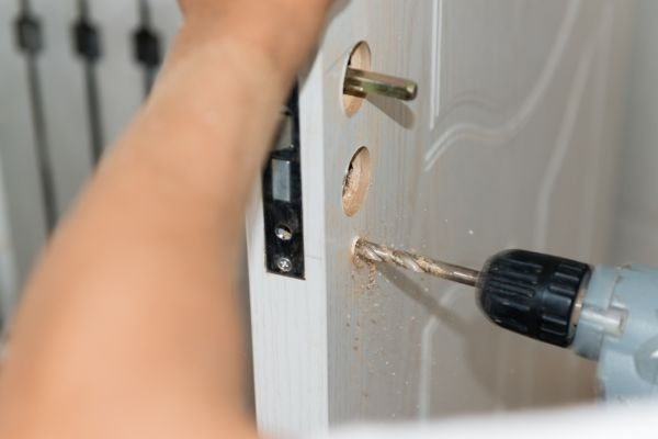a man installing door knob