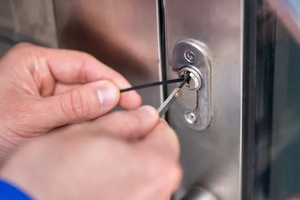 Locksmith repairing front entry door lock