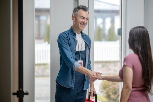 A-satisfied-girl-shaking-hands-to-the-locksmith-5